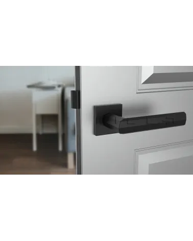 Black FRESIA door handle designer handle front view mounted on a door