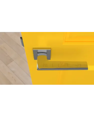 Polished chrome LUNARIA door handle designer handle top view mounted on a door