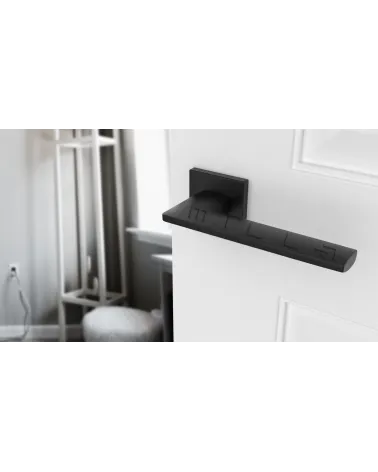 Modern LUNARIA door handle designer handle angled top view mounted on a door