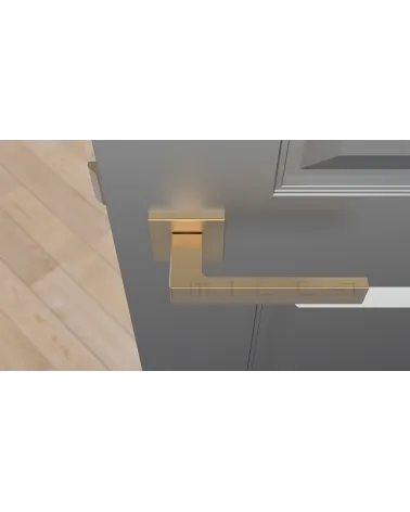 Matt gold SULLA design door handle top view mounted on a door