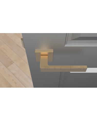 Matt gold SULLA design door handle top view mounted on a door