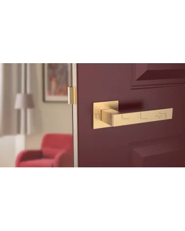 Matt gold SULLA design door handle front view mounted on a door