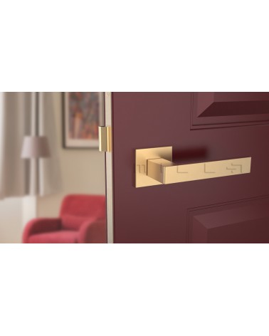 Matt gold SULLA design door handle front view mounted on a door