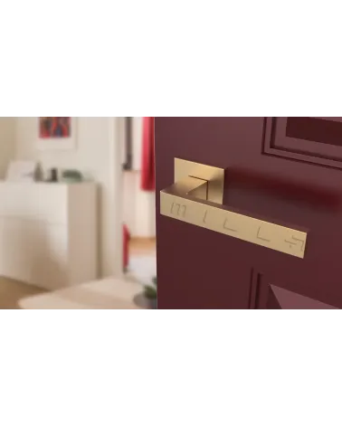 Matt gold SULLA design door handle angled top view mounted on a door
