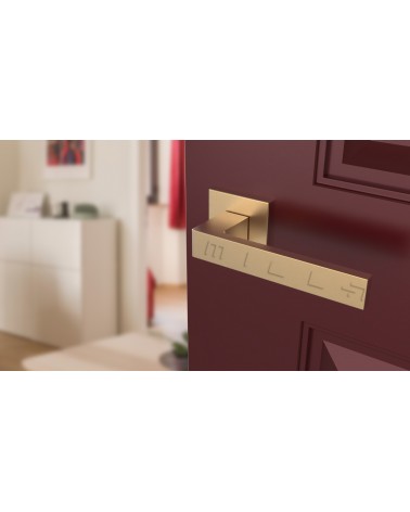 Matt gold SULLA design door handle angled top view mounted on a door