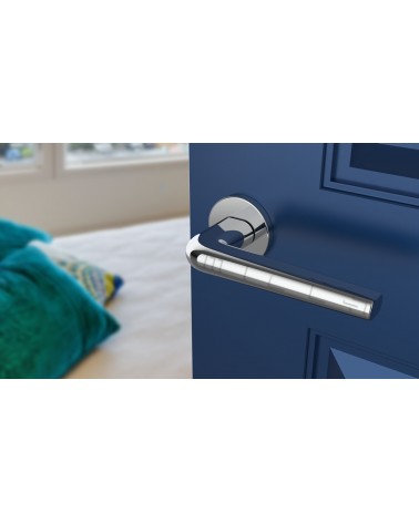 Polished chrome FUNKIA design door handle angled view mounted on a door