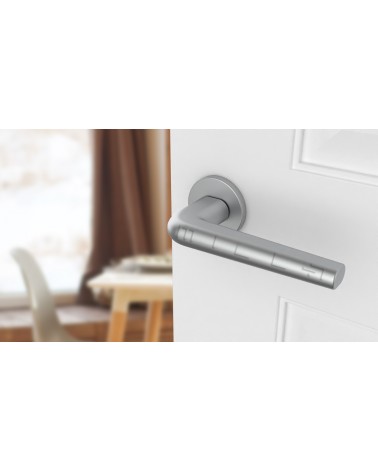 Satin chrome FUNKIA door handle design handle angled top view mounted on a door