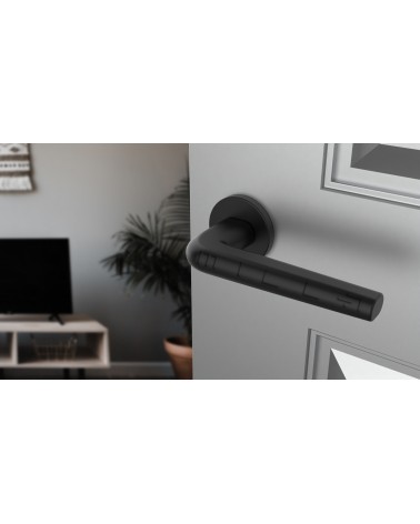 Black FUNKIA door handle design handle angled view mounted on a door