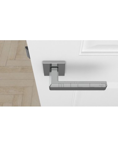 Polished chrome RAFLESIA door handle designer handle top view mounted on a door