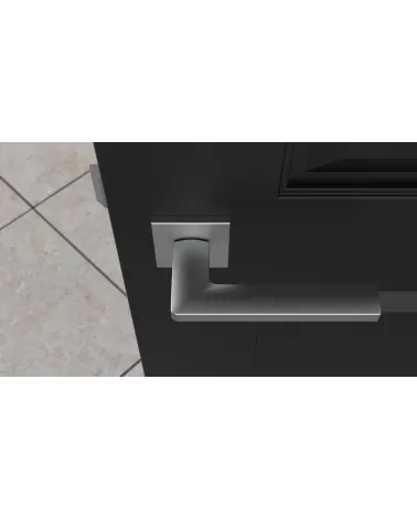PYROLA satin chrome door handle designer hardware top view mounted on a door
