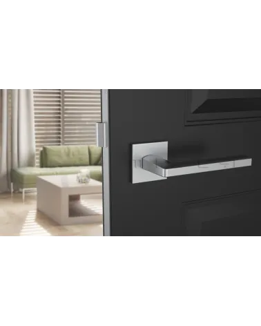 PYROLA satin chrome door handle designer hardware front view mounted on a door