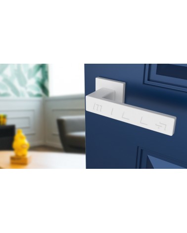 White PINA door handle design angled view mounted on a door