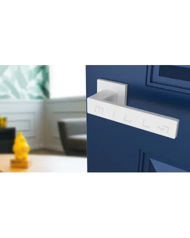 White PINA door handle design angled view mounted on a door