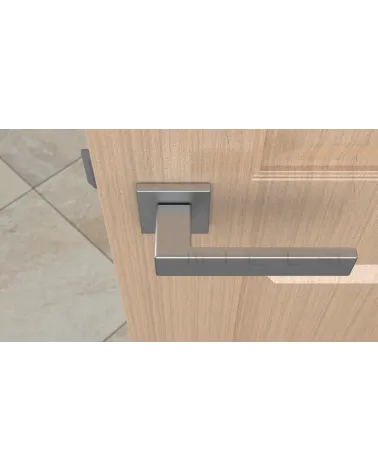 Satin chrome PINA door handle design handle top view mounted on a door