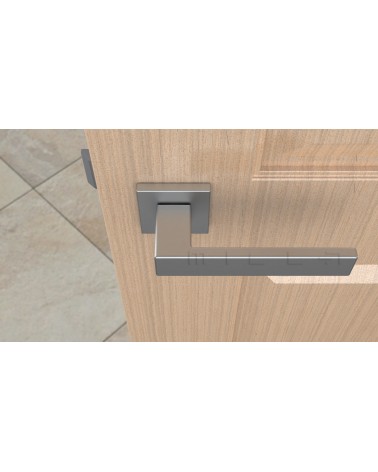 Satin chrome PINA door handle design handle top view mounted on a door