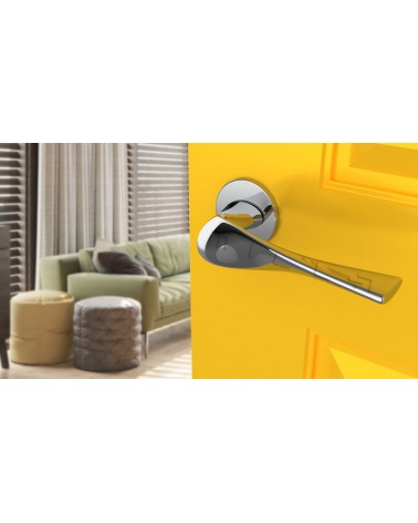 Polished chrome PETUNIA door handle design hardware angled top view mounted on a door