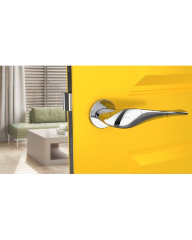 Polished chrome PETUNIA door handle design hardware front view mounted on a door
