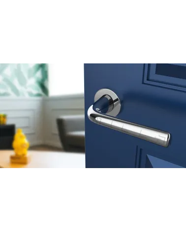 Polished chrome door handle TULIPA interior door design angled view mounted on a door