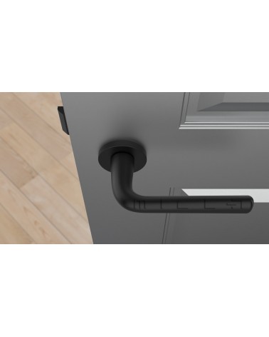 Black TULIPA interior door handle design top view mounted on a door