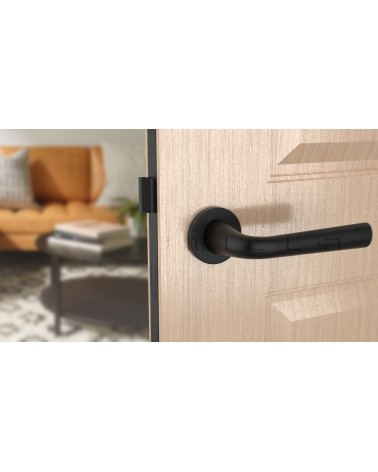 Black TULIPA interior door handle design front view mounted on a door