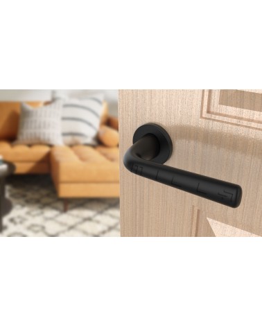 Black TULIPA interior door handle design tilted view mounted on a door