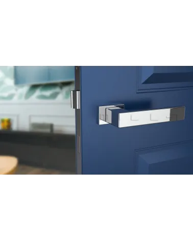PINA polished chrome door handle design handle front view mounted on a door