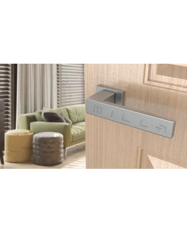 PINA satin chrome door handle design handle angled view mounted on a door
