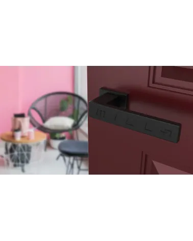 PINA black design door handle angled view mounted on a door