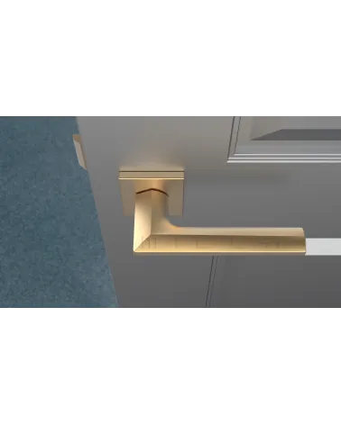 JASMINA matte gold door handle designer handle top view mounted on a door