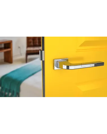Polished chrome ISMENA door handle design ironmongery front view mounted on a door