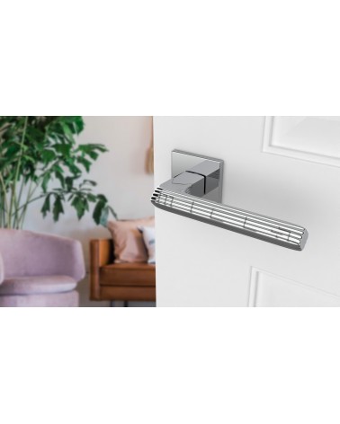 LARICE polished chrome door handle design handle angled top view mounted on a door