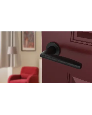 Black LUNA door handle design handle angled view mounted on a door