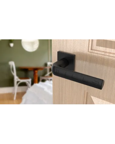 MELA black door handle designer handle angled view mounted on a door