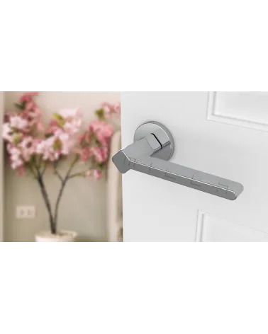 Futuristic style NINFEA door handle design hardware angled top view mounted on a door