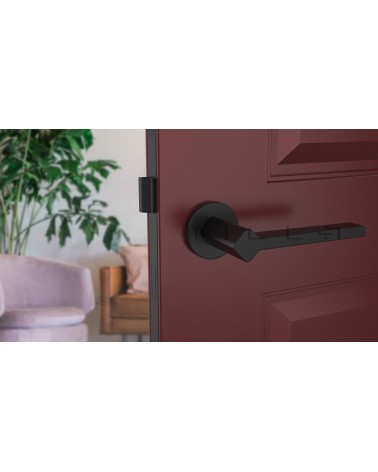 NINFEA black door handle designer ironmongery front view mounted on a door
