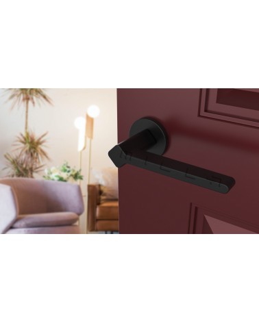 NINFEA black door handle designer ironmongery angled view mounted on a door