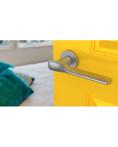 Satin chrome ORCHIDE door handle designer handle angled view mounted on a door