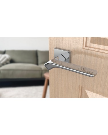 BERGERIA polished chrome door handle designer ironmongery angled view mounted on a door