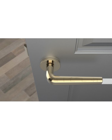 Polished brass door handle INULLA designer handle top view mounted on a door