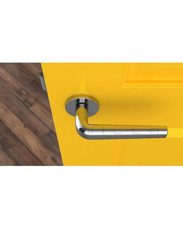 Chrome door handle INULLA designer handle top view mounted on a door