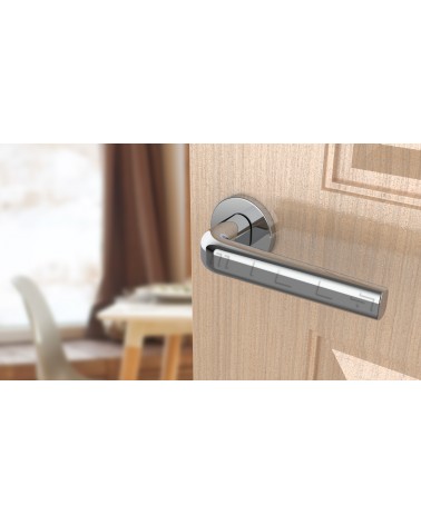 Chrome door handle INULLA designer handle angled view mounted on a door