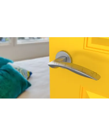 Satin chrome ROBINE door handle design hardware angled top view mounted on a door