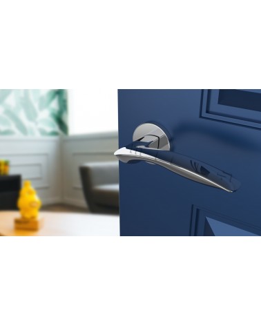 Polished chrome ROBINE door handle design hardware angled top view mounted on a door