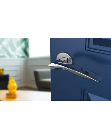 Polished chrome ROBINE door handle design hardware angled top view mounted on a door