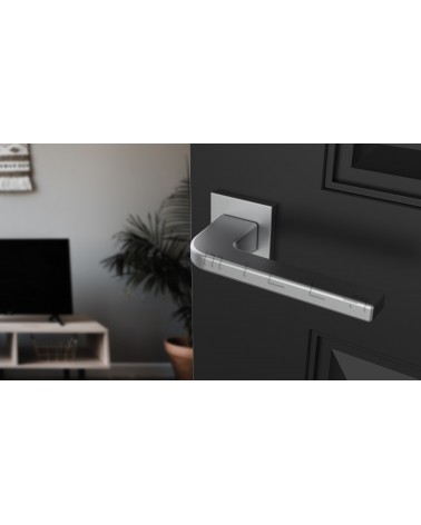 ISMENA door handle designer handle colour 1 mounted on an ajar door