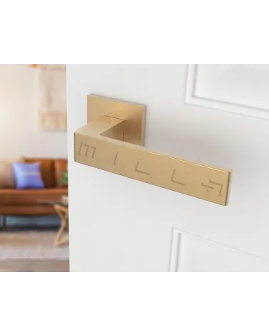 Matt gold Apollo door handle design handle angled view mounted on a door