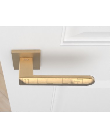 Matt gold BOHEMA door handle on a white door, top view