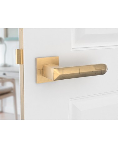 Matt gold BOHEMA door handle on a white door, left side view