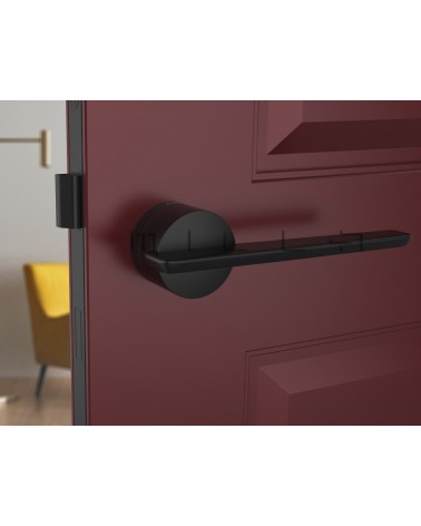 Black JUMELLE design door handle front view mounted on a door