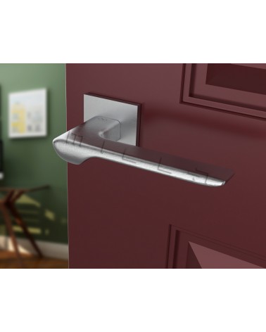 Brushed chrome LINE design door handle angled view mounted on a door